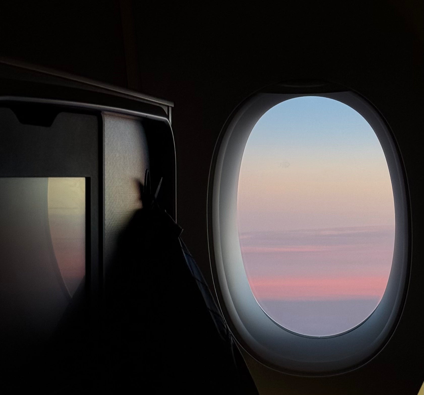     Sunrise above the clouds from an aeroplane window