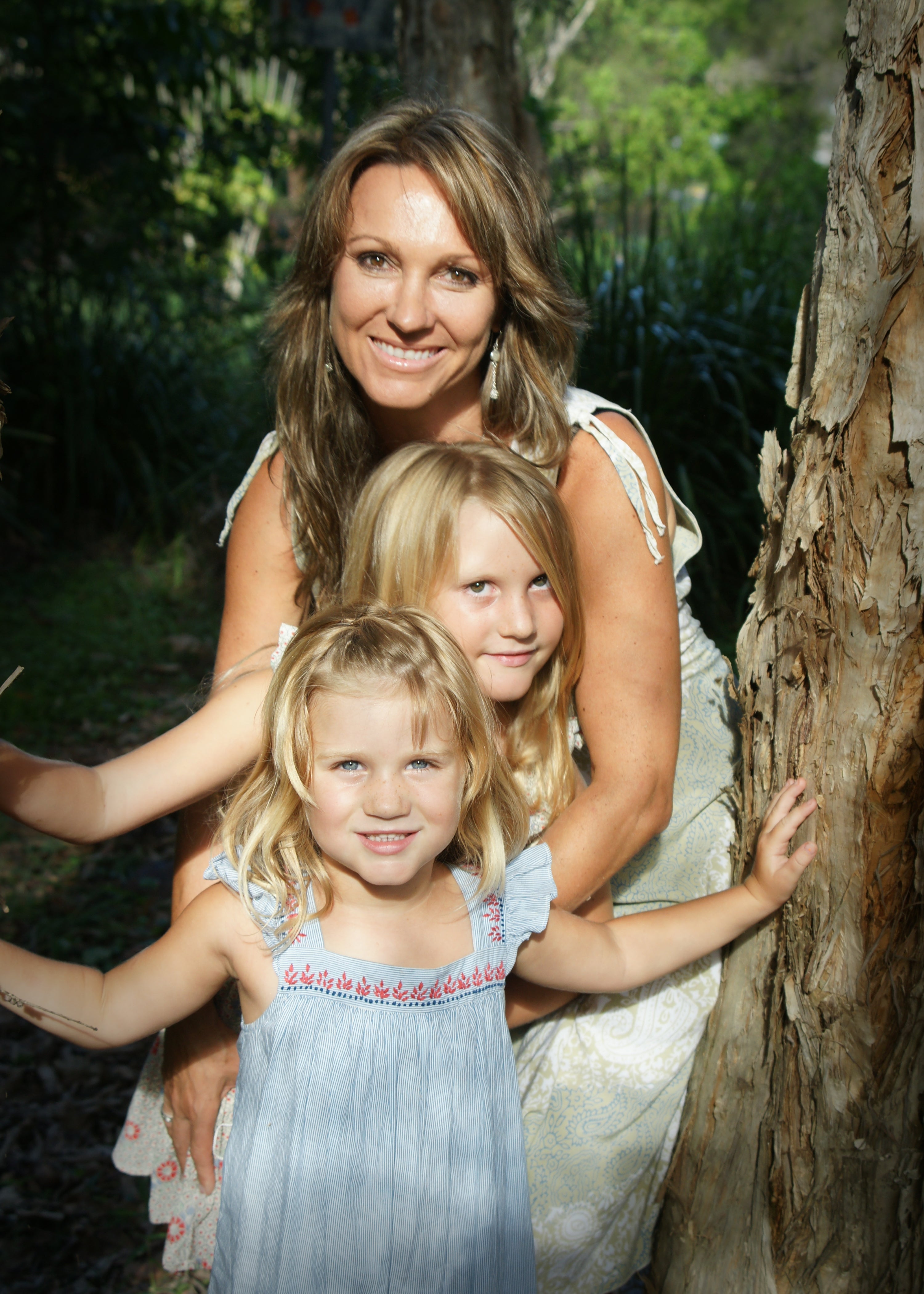 A warm embrace between a mother and her two daughters
