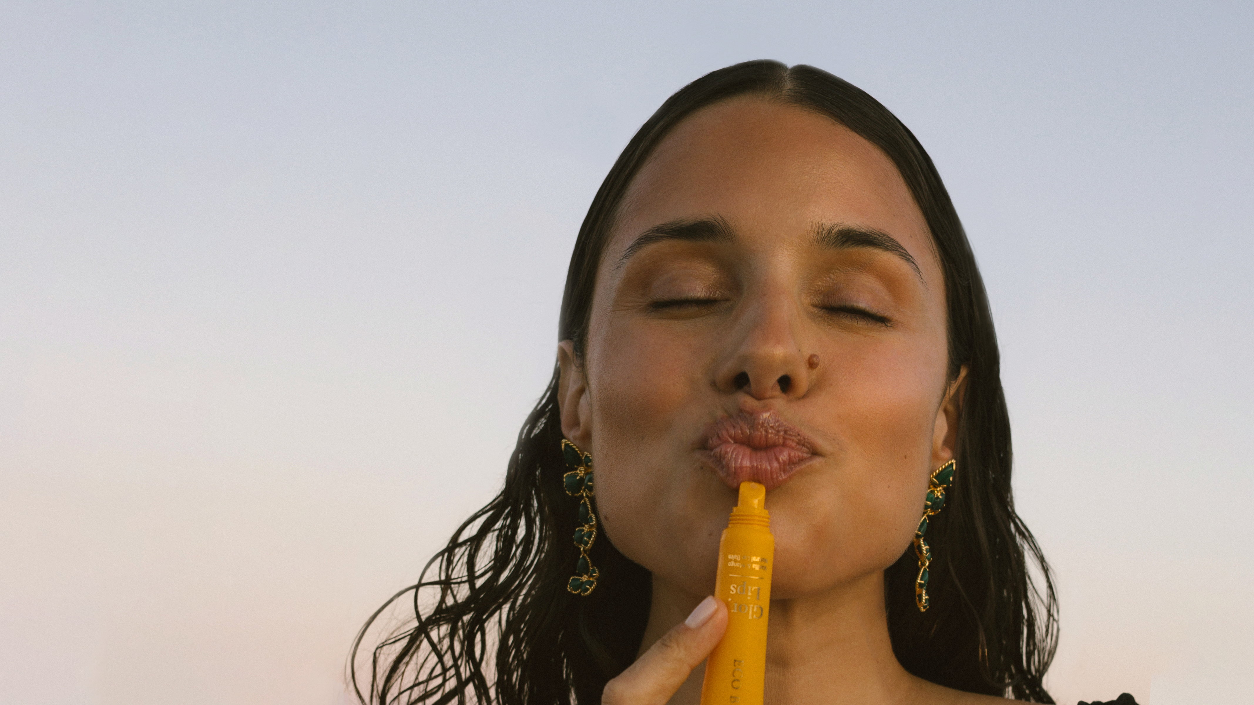 Woman applying Eco By Sonya Glory Lips