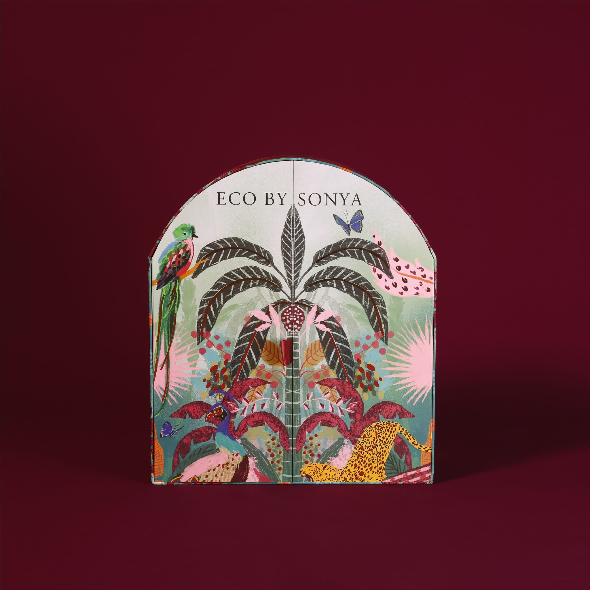 Eco By Sonya The Paradise Collection Christmas Advent Calendar box featuring a colourful tropical jungle pattern on a burgundy background.