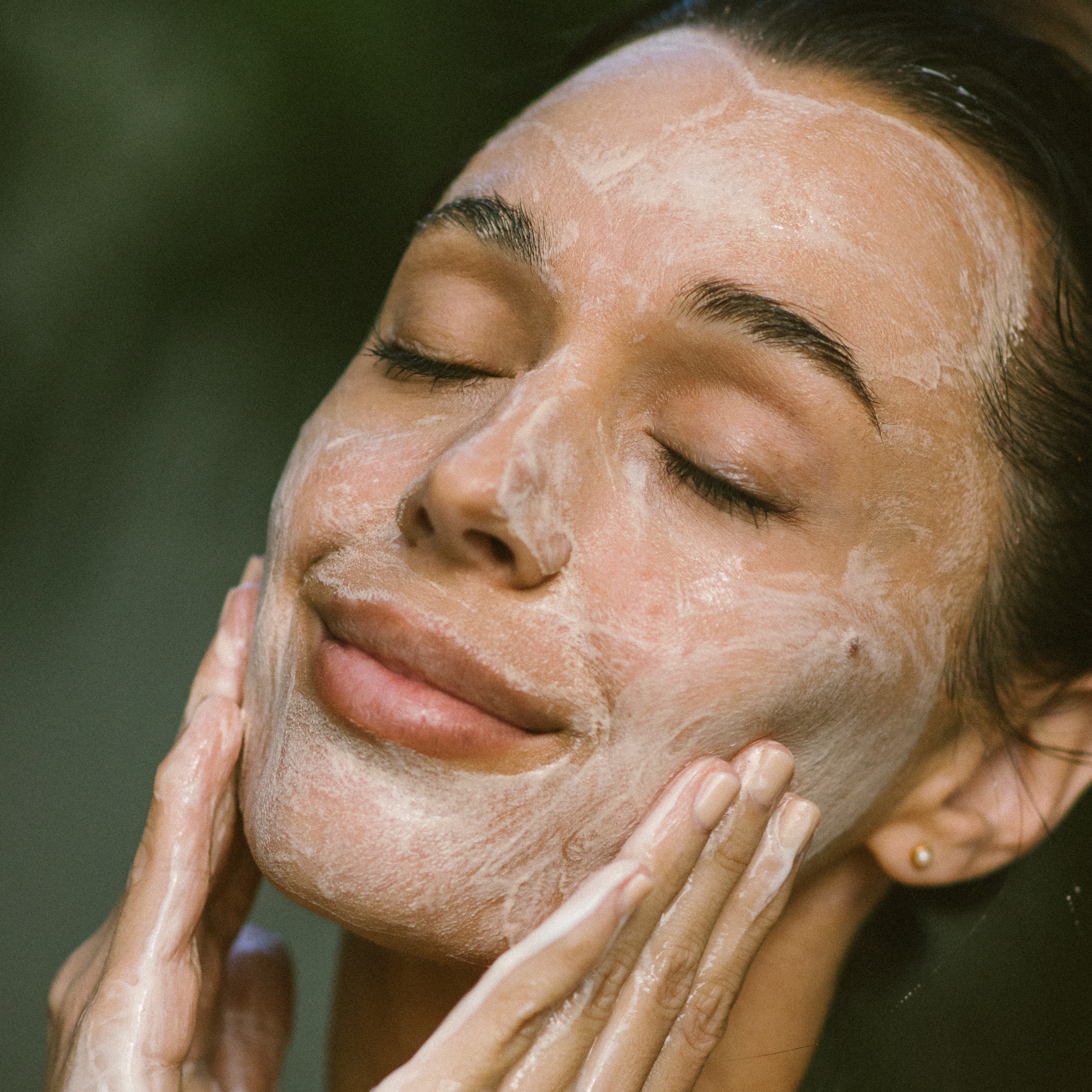 Woman applying Super Citrus Cleanser Gel Face Wash 