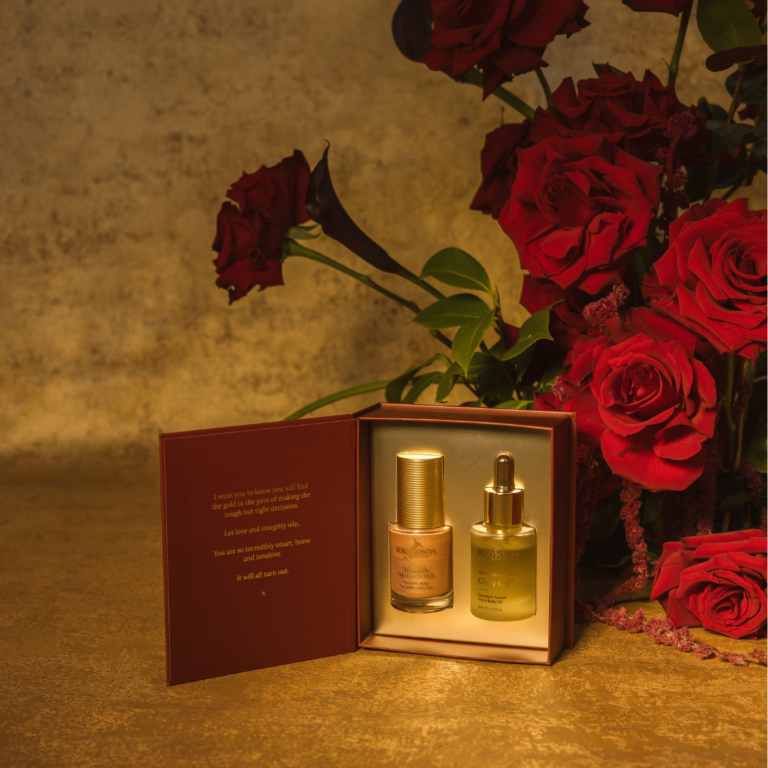 Eco by Sonya festive gift pack with Glory Oil and Golden Illuminiser on gold background with Roses 